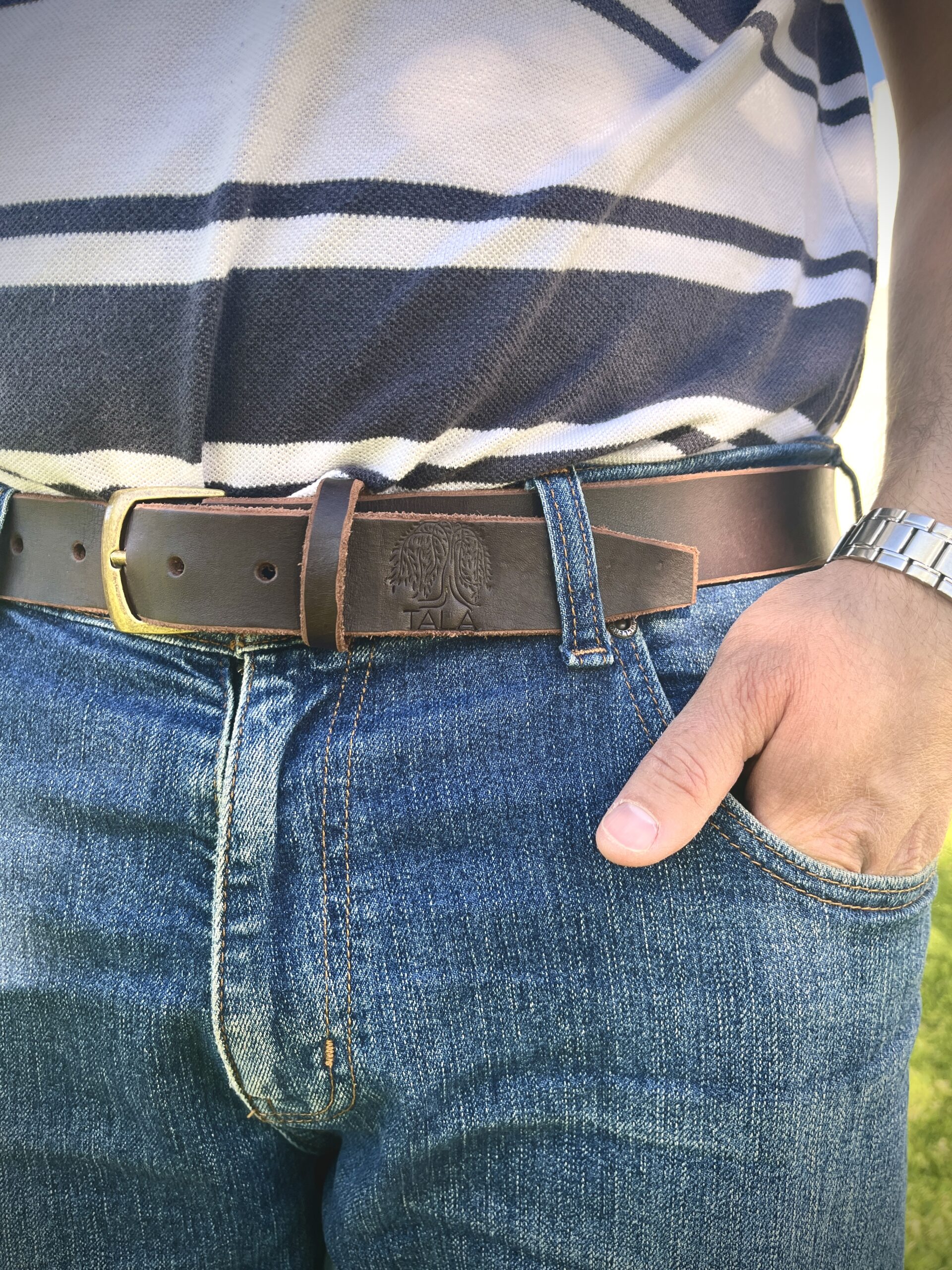 High-quality vegetable-tanned leather belt in brown with a classic buckle and five-hole design.