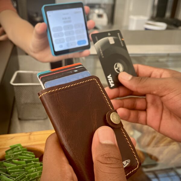 Full-grain leather pop-up cardholder holding up to 8 cards with aluminum alloy mechanism and RFID protection
